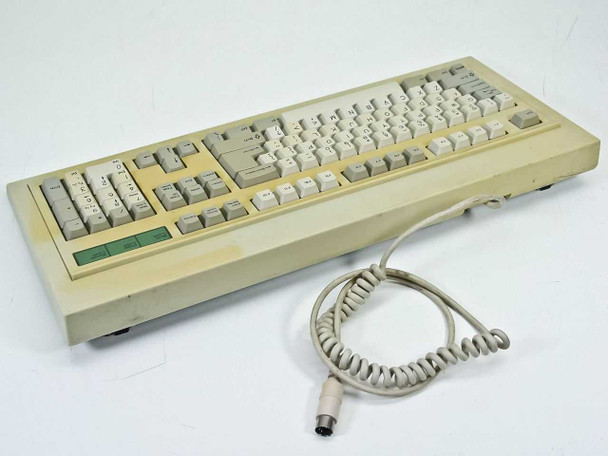BTC 5339R-0 AT Keyboard – rear three-quarter view showing coiled DIN 5-pin connector cord and yellowed case
