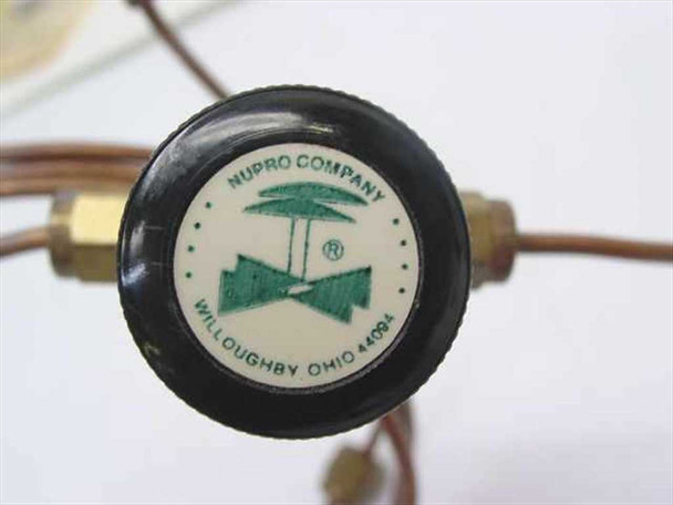 Close-up of Nupro Company needle valve knob showing logo, Willoughby Ohio marking, and green brand emblem