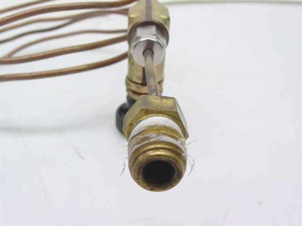 Close-up of second assembly needle valve end showing brass hex body, needle stem extended, and threaded outlet port