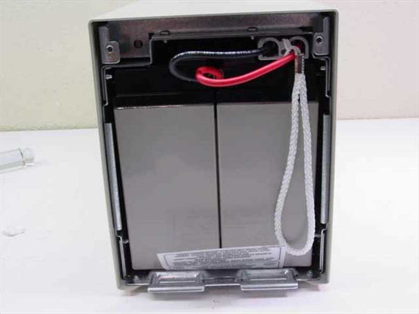 APC SU24XLBP battery compartment open from rear showing empty battery trays, red positive lead, and pull strap