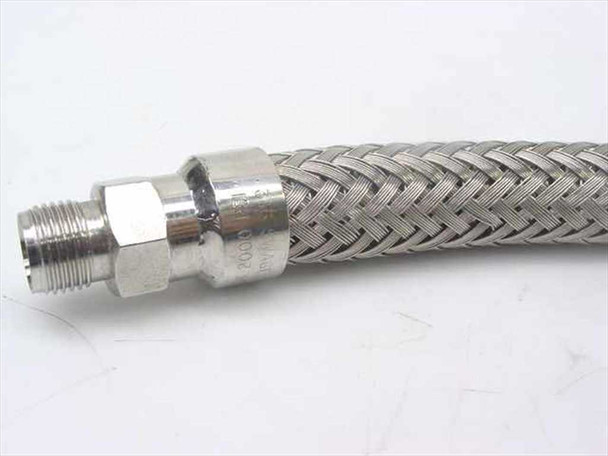 Close-up of opposite male compression fitting end showing stainless threads and pressure rating stamp on fitting body