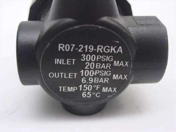 Norgren R07-219-RGKA pressure regulator close-up of rating label: Inlet 300 PSIG / 20 BAR, Outlet 100 PSIG / 6.9 BAR, Temp 150°F / 65°C max