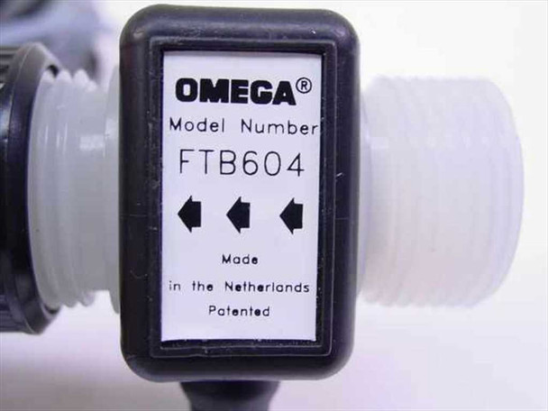 Omega Engineering FTB604 model label showing brand, model number, flow direction arrows, and Made in the Netherlands text