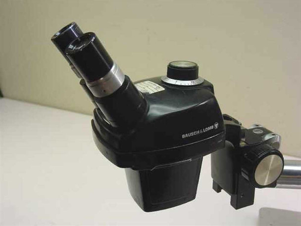 Bausch & Lomb stereo microscope side view showing Bausch & Lomb logo on housing and boom arm clamp assembly