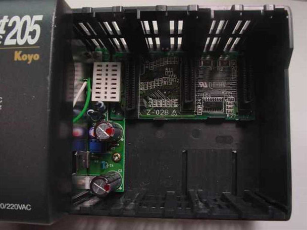 PLC Direct D2-03B DirectLogic 205 interior close-up — Koyo branding visible, two module PCBs installed (Z-02B A board visible), power supply board with capacitors and components