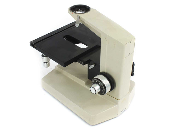 Olympus BHM microscope stand and X/Y stage — left-side three-quarter view showing coarse focus knob and stage tilt