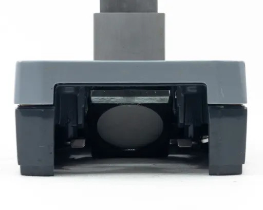 American Optical AO 561-1 base — front view with dark/black stage plate installed (reversed)