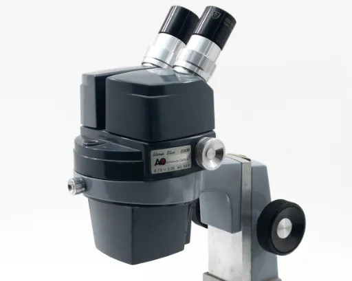 American Optical AO 569 Stereo Star Zoom Microscope with binocular head — left side three-quarter view
