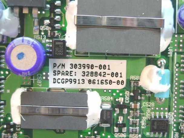 Close-up of Compaq 303990-001 board label showing P/N 303990-001, Spare 328842-001, and date code DCGP9913 061650-00