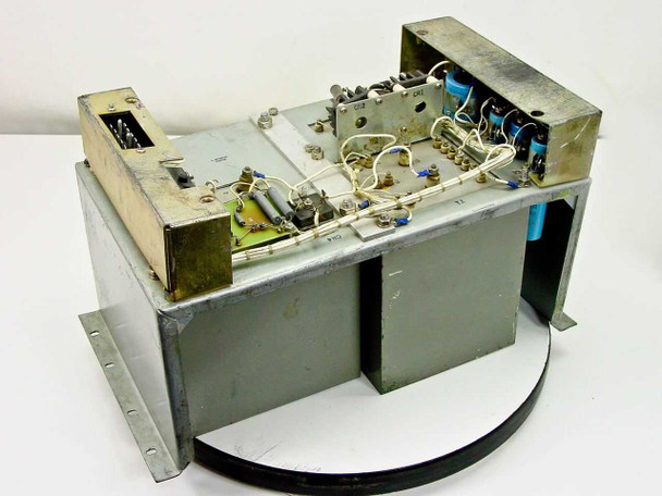 RCA MI-560772 Raw DC Power Supply — angled top view showing internal components including transformer assembly, blue capacitors, and PCB