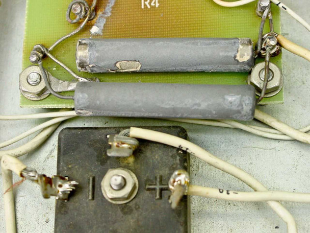 RCA MI-560772 Raw DC Power Supply — close-up of green PCB showing wire-wound resistors and diode bridge rectifier block with polarity markings