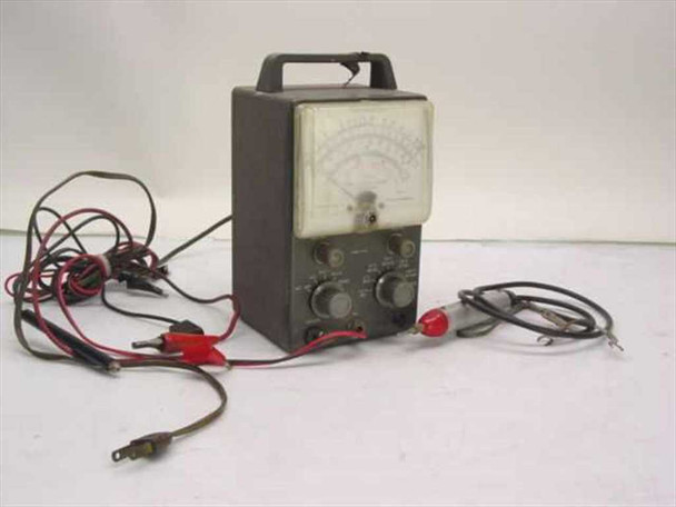 Heathkit V-7A Vacuum Tube Voltmeter VTVM — front view showing analog meter face, two control knobs, carry handle, and test leads with alligator clips spread around unit