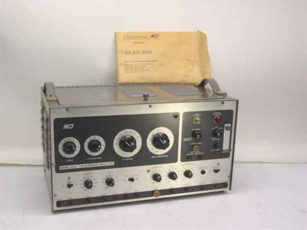 B&K 1076 Television Analyst Pattern Generator — front panel view showing knobs, indicator lights, and output jacks; documentation insert visible behind unit