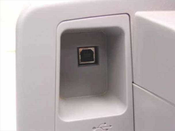 Canon PIXMA iP1500 rear USB Type-B port close-up with USB symbol below recessed connector