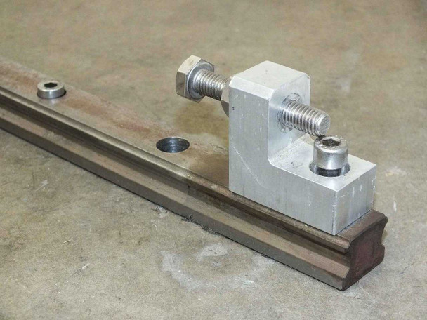 UG9K83 linear rail end section detail showing end stop bracket hardware and rail profile from above