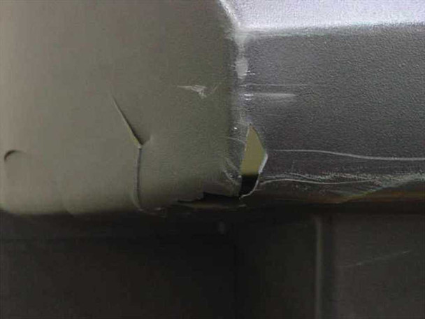 Philips 55PW9317 close-up of upper corner — significant cracking and chipping of plastic enclosure at corner