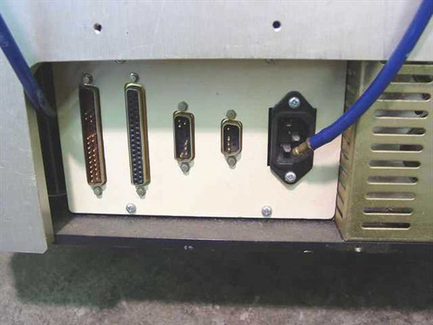 Amistar PlaceMaster FP — rear bottom panel showing parallel interface connector, two DB9 serial connectors, and IEC AC power inlet with blue pneumatic hose