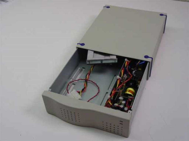 SCSI enclosure with lid open showing empty 3.5-inch drive bay, internal power supply board with transformer, and multi-colored power cables