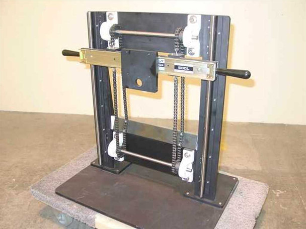 Gravity hoist faceplate mount dual chain counterbalance assembly – front three-quarter view showing THK linear slide, dual roller chains, black steel frame, and handle grips