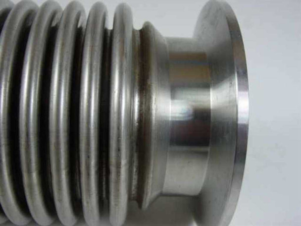 Close-up of MKS HPS vacuum bellows corrugated convolutions and smaller flange end showing surface discoloration