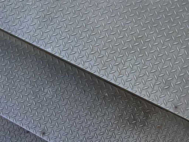 Close-up of aluminum diamond plate surface texture on work platform steps and deck