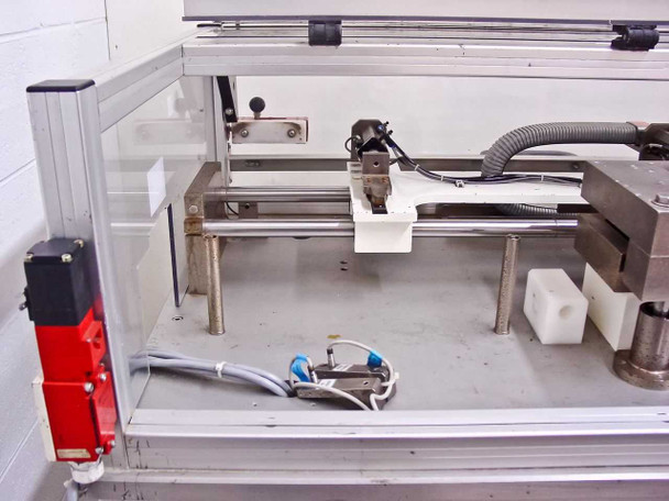 Pneumatic linear motion table interior – showing shuttle carriage, pneumatic cylinders, guide rails, and tooling fixture on aluminum frame