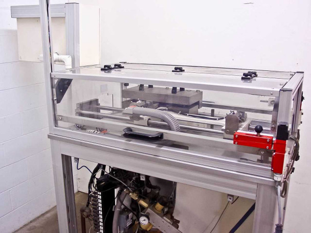 Pneumatic motion table overhead view – showing full linear shuttle rail assembly with clear acrylic safety guarding and boat fixture in retracted position