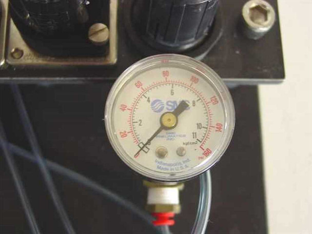 Close-up of SMC dial pressure gauge showing psi and kgf/cm² scales, Indianapolis Made in USA, with adjustment knob visible on mounting block