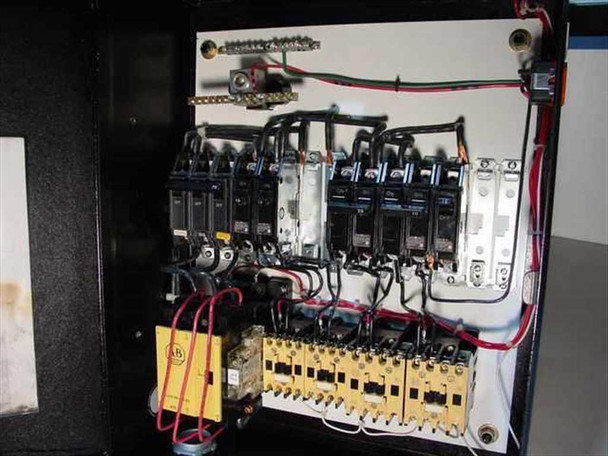 Interior of custom breaker box enclosure — full view showing 70A 3-pole and multiple 15A/20A single-pole breakers, Allen-Bradley yellow motor starters, terminal blocks, and red/black wiring