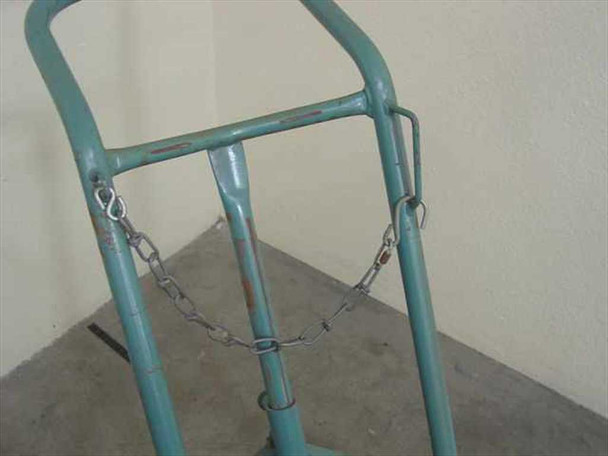Close-up of gas cylinder cart upper frame showing steel safety chain with S-hooks attached across the upright rails