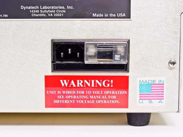 Dynatech Fluorolite 1000 – rear view close-up of IEC power inlet, fuse holder, and warning label indicating unit wired for 115V operation