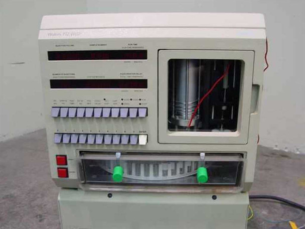 Waters 712 WISP Autosampler – full front view showing sample carousel tray, front panel controls, LED status displays, and needle/syringe assembly behind glass door