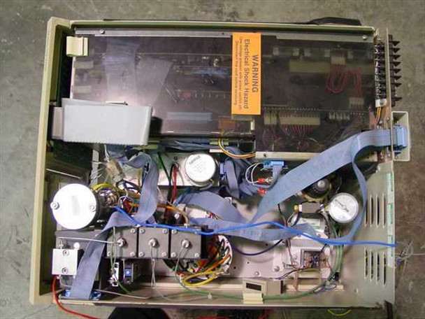 Waters 712 WISP – internal top-down view with cover removed showing motor drive assemblies, wiring harness, PCBs, and electrical components; Electrical Shock Hazard warning label visible