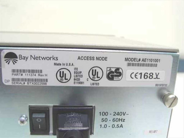 Bay Networks AE1101001 rating label showing Part 111374 Rev H, Model AE1101001, Serial BTX0022598, 100-240V 50-60Hz 1.0-0.5A, Made in USA, UL/CE/GS certifications