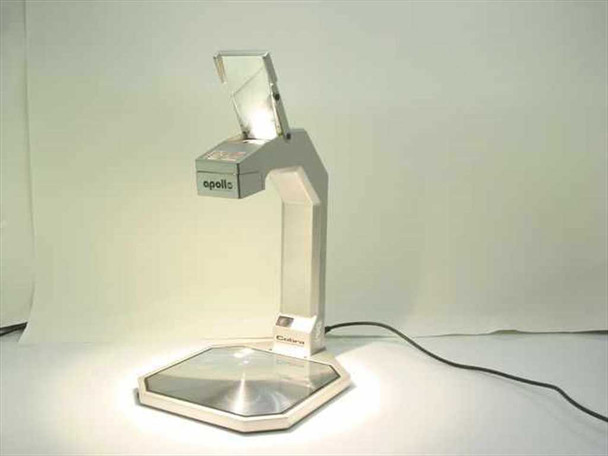 Apollo Cobra VS3000 portable reflective overhead projector powered on, showing illuminated Fresnel lens base and folded arm with projection head — front-right view