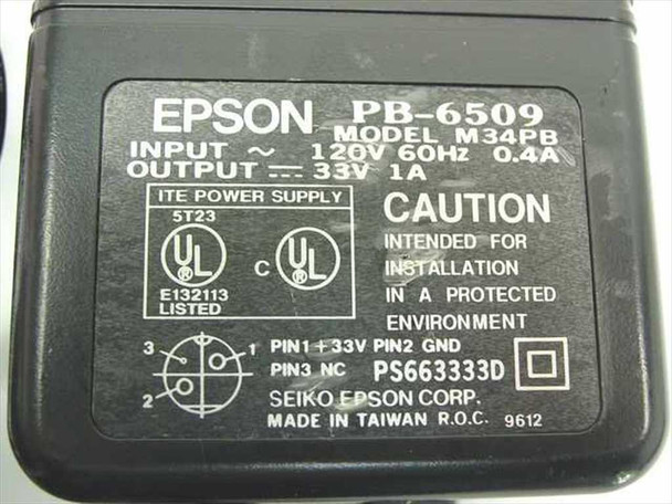 Epson PB-6509 M34PB rating label showing 120V 60Hz input, 33V DC 1A output, UL listing, and Seiko Epson Corp. Made in Taiwan markings
