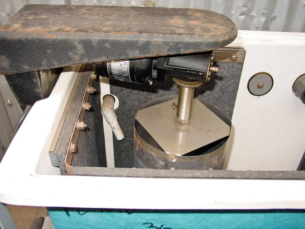 Interior view of silver recovery tank with lid open — stainless steel cylindrical drum circulator assembly with paddle impeller on shaft, plumbing fittings along interior side wall