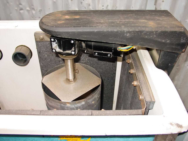 Interior tank view with lid lifted — circulator drum assembly with paddle impeller and shaft visible, mounting hardware and wiring connections, tank interior showing staining and residue