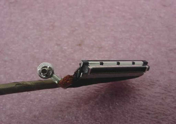 Close-up of Dell CN-06M871 LCD harness multi-pin flat connector end with attached ground wire and ferrite bead