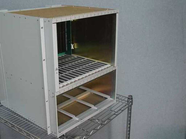 Nortel Passport 6480 NTJS61BA chassis — right-side angle view showing card cage interior with backplane connector visible at rear right and power supply bay guide rails below