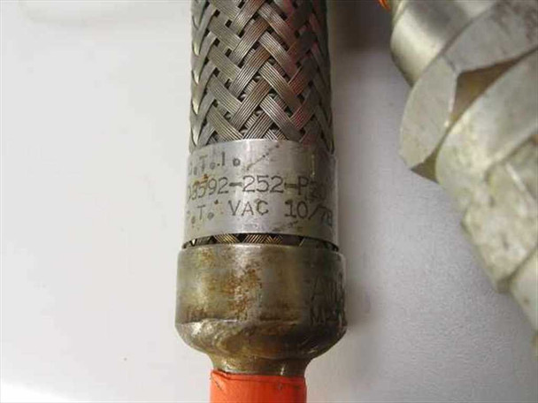 Close-up of CTI-Cryogenics D3592-252-P20 flex line fitting showing embossed part number label and VAC date code with surface oxidation on the stainless steel collar
