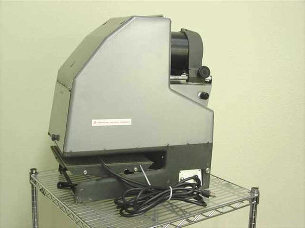 American Optical 3525 HS Delineascope opaque projector — right-side view showing flat rear panel with American Optical Company nameplate and lens assembly, on wire shelf