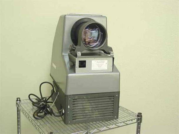 American Optical 3525 HS Delineascope opaque projector — three-quarter front view showing large projection lens, ventilated lower housing, and power cord, on wire shelf