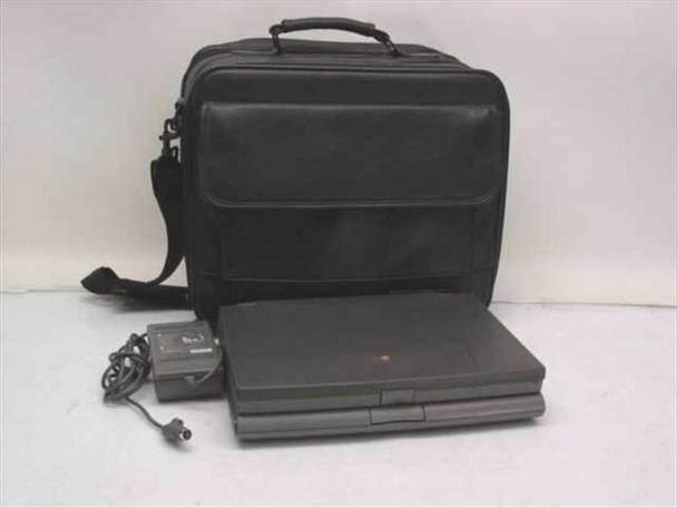 Apple PowerBook 520 laptop closed, shown with black soft-sided carry case with shoulder strap and Apple AC adapter