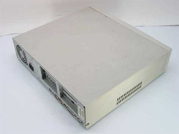AST Bravo MS P/100 desktop computer rear-right view showing back panel with power supply fan, IEC inlet, and expansion slot covers