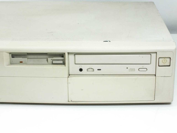 Close-up of AST Bravo MS P/100 front drive bay area showing 3.5-inch floppy drive, CD-ROM drive, and power button with case yellowing