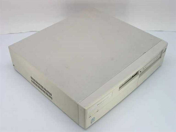 AST Bravo MS P/100 desktop computer front-left view showing beige case with floppy and CD-ROM drives, yellowed top surface with dust