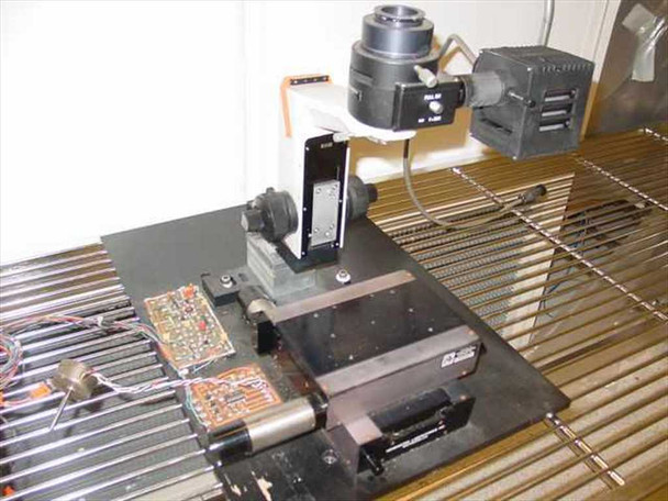 Olympus BHM microscope assembly left-side view — Kensington Labs 6000 4x4 linear stage and motorized PCBs visible on custom mount plate
