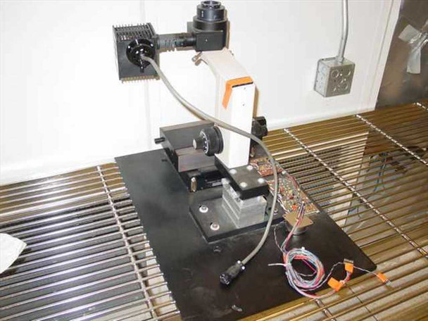 Olympus BHM microscope assembly rear-right view — orange-tagged wiring harness, circuit boards, and lamp housing attachment visible