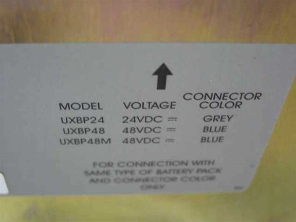 APC UXBP24 label showing model/voltage/connector color chart: UXBP24 = 24VDC Grey, UXBP48 = 48VDC Blue, UXBP48M = 48VDC Blue
